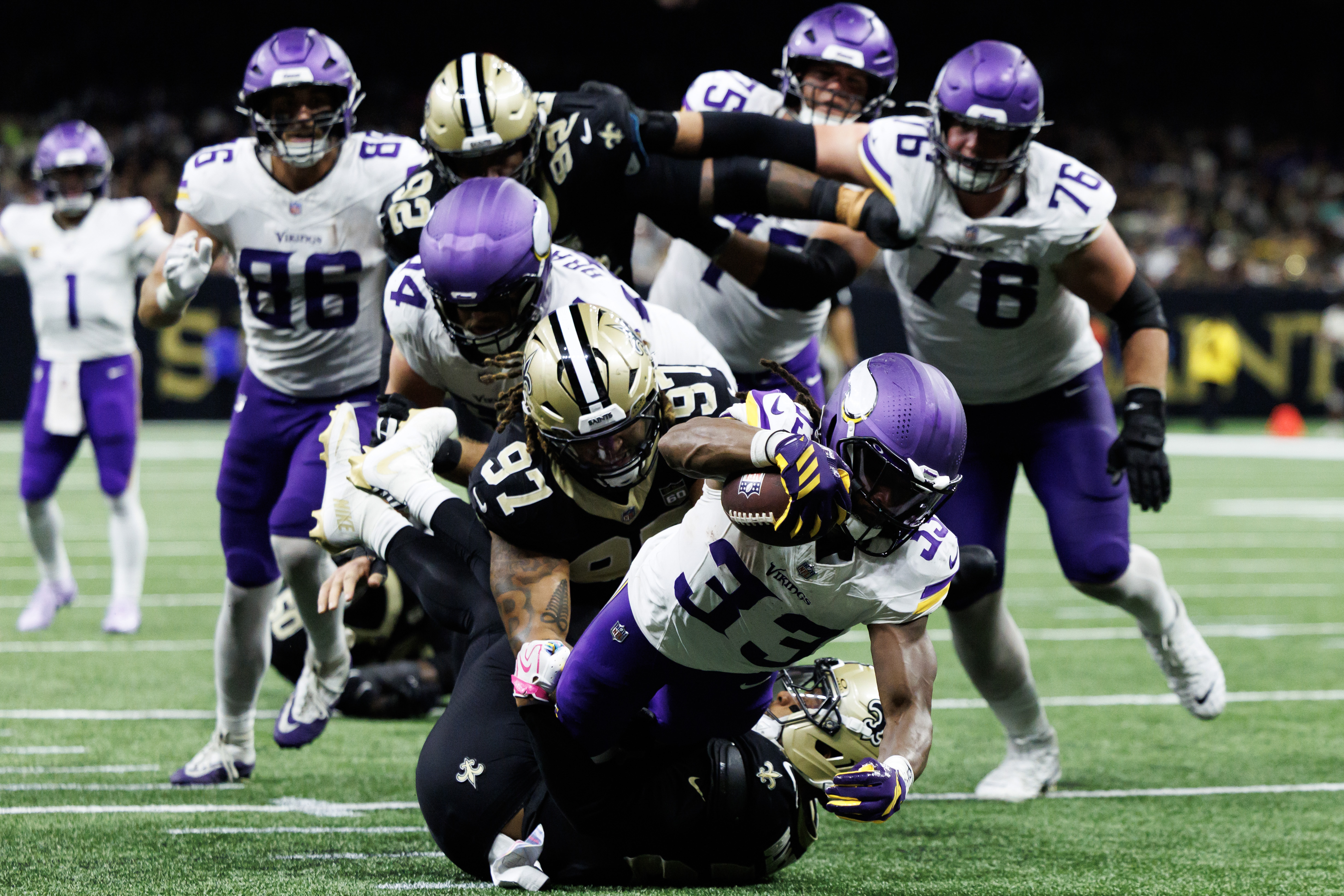 NEW ORLEANS, LOUISIANA - OCTOBER 11: Aaron Jones #33 of the Minnesota Vikings scores a rushing a touchdown during the third quarter of a game against the New Orleans Saints at Caesars Superdome on October 11, 2026 in New Orleans, Louisiana.
