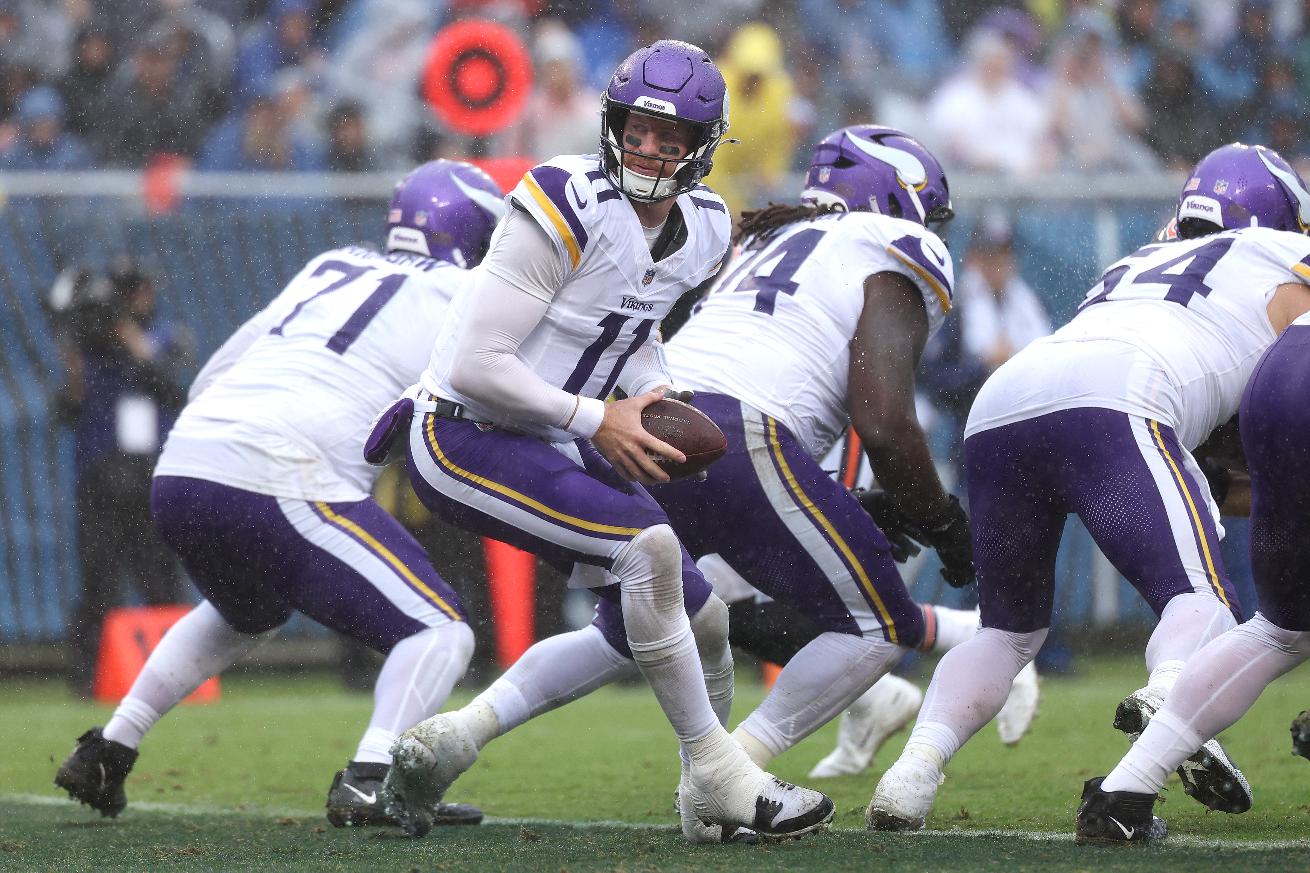 CHICAGO, ILLINOIS - SEPTEMBER 20: Carson Wentz #11 of the Minnesota Vikings scrambles with the ball against the Chicago Bears during the fourth quarter of the game at Soldier Field on September 20, 2026 in Chicago, Illinois.